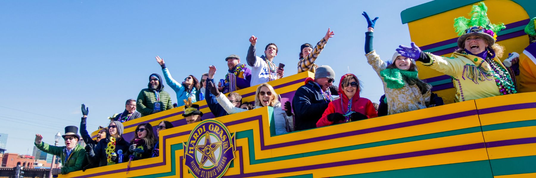 People throw beads from a float during Mardi Gras in Soulard St Louis.